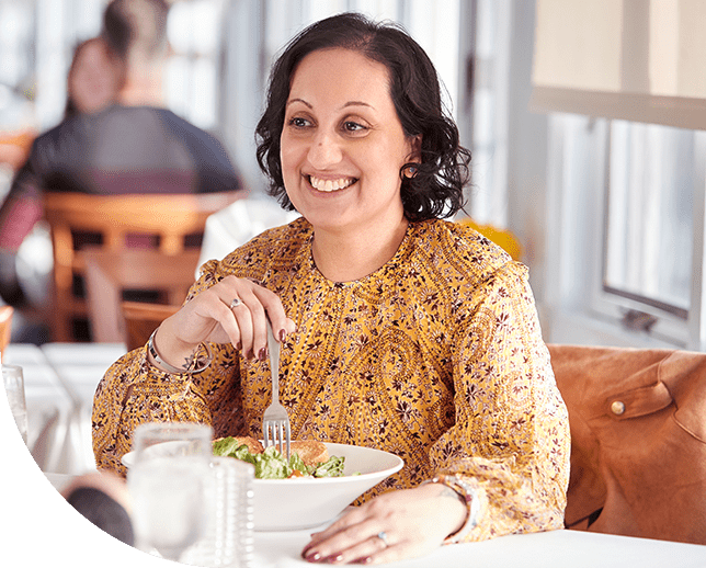 Aimovig® patient, Pooja, at a restaurant