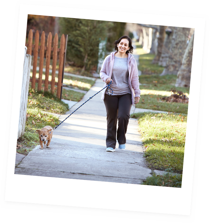 Aimovig® patient, Pooja, walking her dog