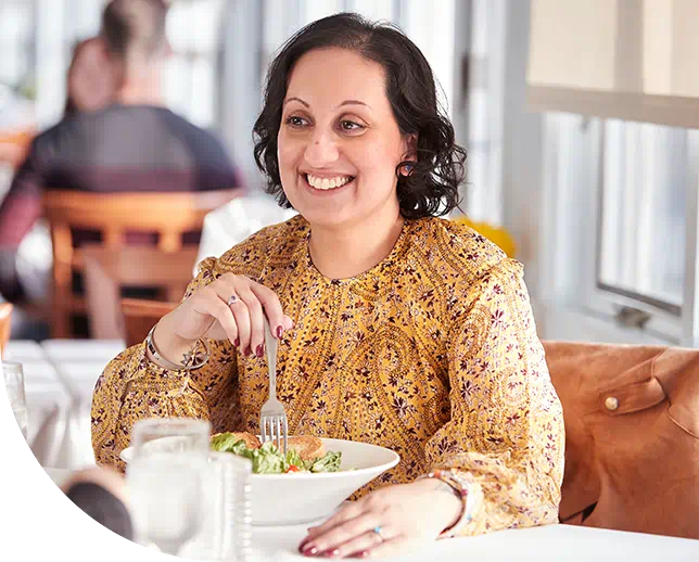 Aimovig® patient, Pooja, at a restaurant